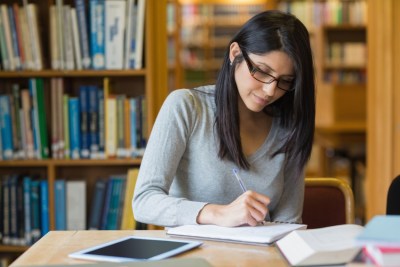 young-woman-student-academic-writing-library